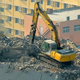 Illustration for article titled Why Is This Excavator Excavating A 12-Story Building From The Top Down?